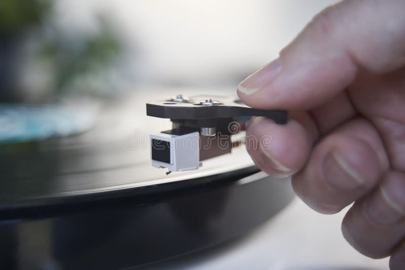 close-up-vinyl-record-player-needle-turntable-hand-putting-lp-173133209.jpg