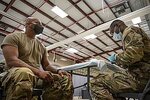 A US. service member prepares to get a COVID-19 vaccine at Fort Knox.jpg