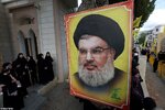 90208741-13901583-People_stand_near_a_picture_of_Hezbollah_leader_Sayyed_Hassan_Na-a-14_172752...jpg