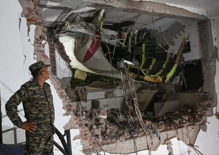 A military official inspects the Air India crash site at BJ Medical College hostel in Ahmedabad, India, on June 13 2025 