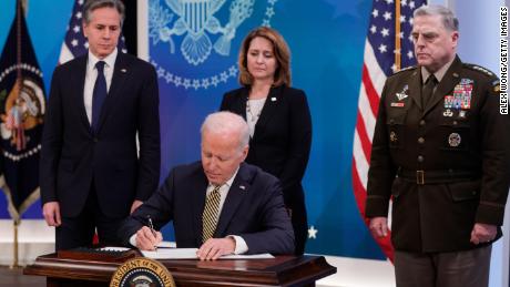 U.S. President Joe Biden signs legislative action to provide security aid and support to Ukraine as Secretary of State Antony Blinken (L), Deputy Secretary of Defense Kathleen Hicks and Chairman of the Joint Chiefs of Staff General Mark Milley look on.