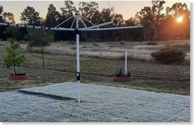 The hills hoist, an Australian invention, in a frozen backyard.