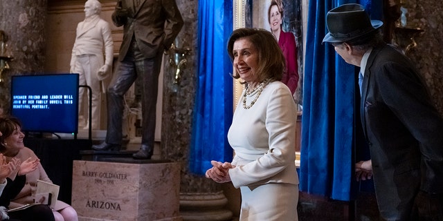 Speaker of the House Nancy Pelosi, D-Calif., is joined by her husband Paul Pelosi as they attend her portrait unveiling ceremony in Statuary Hall at the Capitol in Washington, Wednesday, Dec. 14, 2022. 