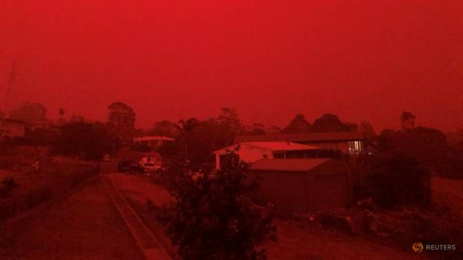 The sky glows red as surrounding wildfires close in on the town of Mallacoota, Victoria, Australia