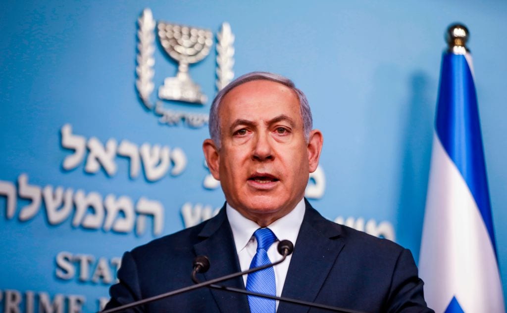 Israeli Prime Minister Benjamin Netanyahu gives an address from his office in Jerusalem on 3 April 2019, announcing that the remains of Sergeant First Class Zachary Baumel, a soldier missing since the 1982 Lebanon war, had been returned to the country. [MENAHEM KAHANA/AFP/Getty Images]