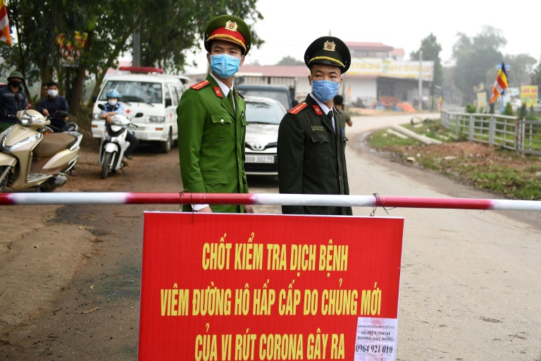 Vietnamese police stand guard at a checkpoint set up at the Son Loi commune in Vinh Phuc province amid concerns about a Covid-19 coronavirus outbreak.