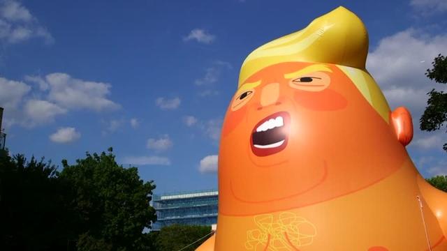 Protesters in London inflate a blimp depicting Donald Trump as a snarling, nappy-wearing orange baby as a trial run ahead of his planned state visit next month. Rough cut (no reporter narration).