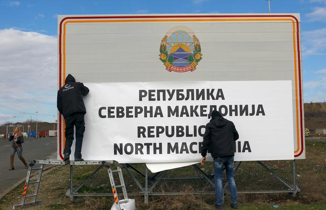 Workers set up a sign with Macedonia's new name at the border between Macedonia and Greece, near Gevgelija, Macedonia February 13, 2019. REUTERS/Ognen Teofilovski?