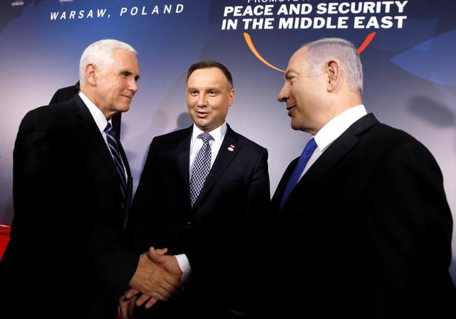 U.S. Vice President Mike Pence and Israeli Prime Minister Benjamin Netanyahu shake hands next to Polish President Andrzej Duda during the family photo at the Middle East conference at the Royal Castle in Warsaw, Poland, February 13, 2019. REUTERS/Kacper Pempel