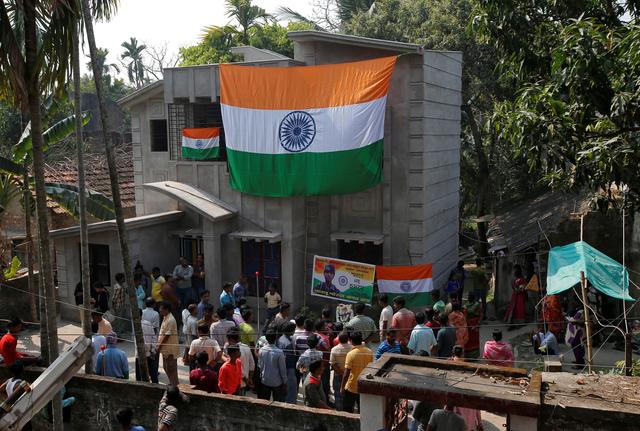 People stand outside the house of Bablu Santra, a Central Reserve Police Force (CRPF) member, who was killed after a suicide bomber rammed a car into the bus carrying CRPF personnel on Thursday, at Bauria village in Howrah district in the eastern state of West Bengal, India, February 15, 2019. REUTERS/Rupak De Chowdhuri
