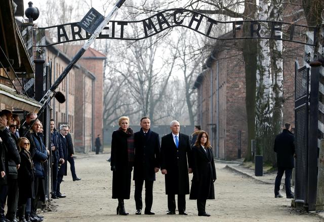 U.S. Vice President Mike Pence with his wife Karen and Poland's President Andrzej Duda with first lady Agata Kornhauser-Duda stand at the "Arbeit Macht Frei" gate at the former Nazi German concentration and extermination camp Auschwitz in Oswiecim, Poland, February 15, 2019. REUTERS/Kacper Pempel    