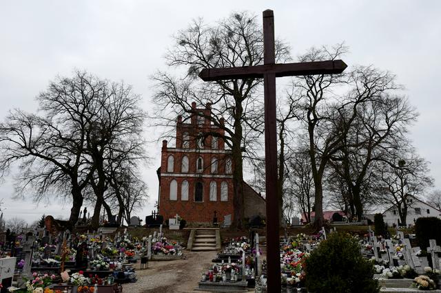 The Church of Saint Jacob is pictured behind the cemetery in Ostrowite village, Poland February 17, 2019. Picture taken February 17, 2019. REUTERS/Kacper Pempel