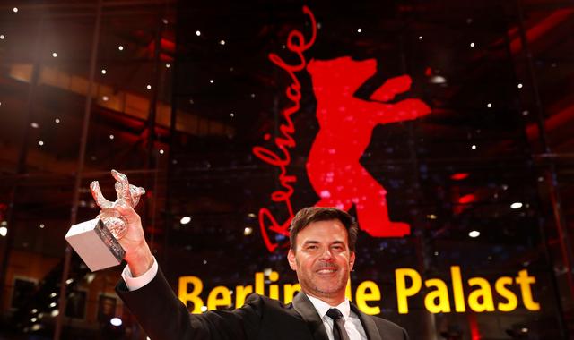FILE PHOTO: Francois Ozon poses with Silver Bear Grand Jury Prize for the film "By the Grace of God", after the awards ceremony at the 69th Berlinale International Film Festival in Berlin, Germany, February 16, 2019. REUTERS/Fabrizio Bensch/File Photo