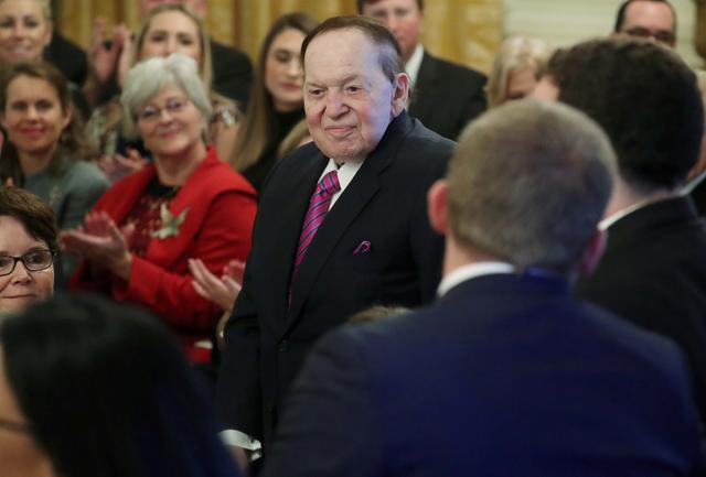 FILE PHOTO: Casino magnate and Republican political contributor Sheldon Adelson stands to be recognized as he attends a ceremony where U.S. President Donald Trump is awarding a Presidential Medal of Freedom to his wife Miriam Adelson in the East Room of the White House in Washington, U.S. November 16, 2018. REUTERS/Jonathan Ernst/File Photo
