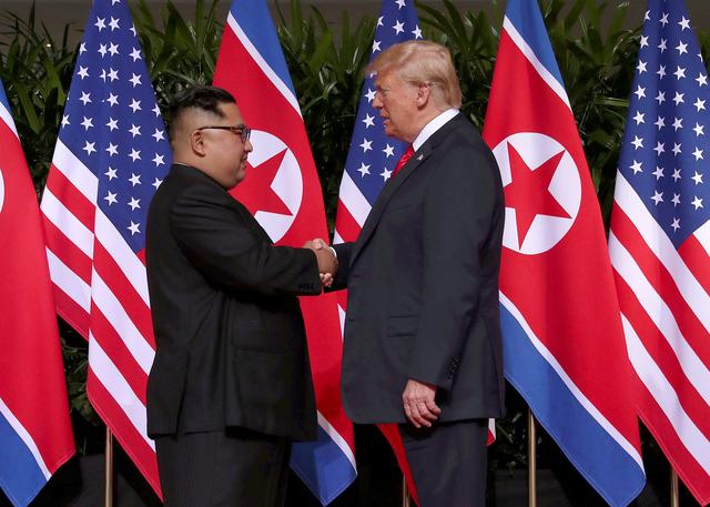 FILE PHOTO: U.S. President Donald Trump shakes hands with North Korean leader Kim Jong Un at the Capella Hotel on Sentosa island in Singapore June 12, 2018. REUTERS/Jonathan Ernst/File Photo