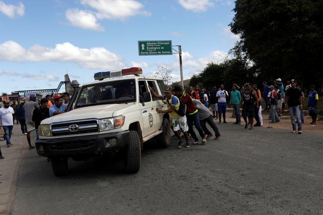 An ambulance carrying people that were injured during clashes, is assisted on the Venezuelan side at the border between Venezuela and Brazil in Pacaraima, Roraima state, Brazil, February 22, 2019. REUTERS/Ricardo Moraes