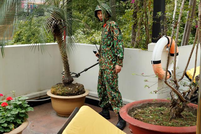 A Vietnamese soldier uses a metal detector at a Hilton hotel's terrace ahead of the North Korea-U.S. summit in Hanoi, Vietnam, February 24, 2019. REUTERS/Jorge Silva