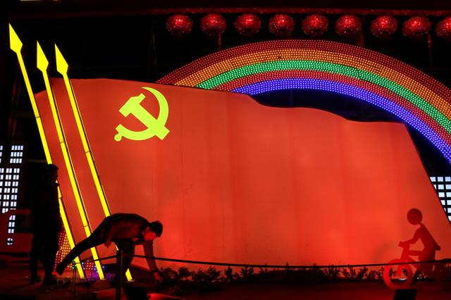 FILE PHOTO: Men check on a light installation in a shape of the party flag of the Communist Party of China, that is set up to celebrate the upcoming Chinese Lunar New Year, in Jining, Shandong province, China January 29, 2019. Picture taken January 29, 2019.  REUTERS/Stringer