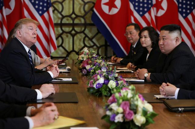 North Korea's leader Kim Jong Un listens as U.S. President Donald Trump speaks during the extended bilateral meeting in the Metropole hotel during the second North Korea-U.S. summit in Hanoi, Vietnam February 28, 2019. REUTERS/Leah Millis