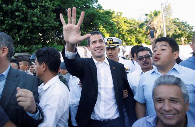 Venezuelan opposition leader Juan Guaido, who many nations have recognized as the country's rightful interim ruler, gestures after a meeting with Ecuador's President Lenin Moreno (R) in Salinas, Ecuador March 2, 2019. REUTERS/Daniel Tapia