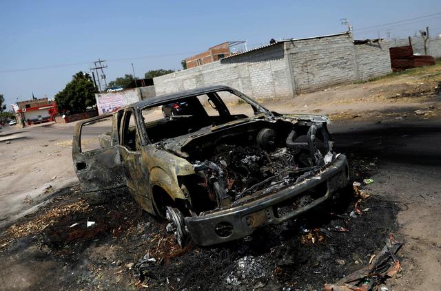 The wreckage of a car that was burnt in a blockade set by members of the Santa Rosa de Lima Cartel to repel security forces during an anti-fuel theft operation is pictured in Santa Rosa de Lima, in Guanajuato state, Mexico, March 6, 2019. REUTERS/Edgard Garrido