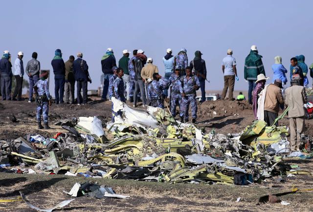 Ethiopian Federal policemen stand at the scene of the Ethiopian Airlines Flight ET 302 plane crash, near the town of Bishoftu, southeast of Addis Ababa, Ethiopia March 11, 2019. REUTERS/Tiksa Negeri