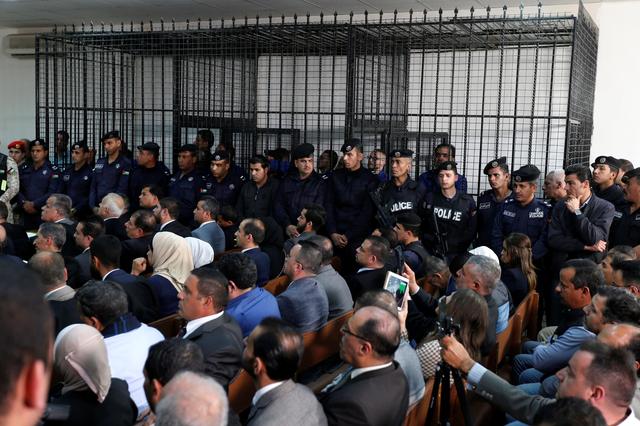 Accused men are seen behind bars during a trial held for over 30 businessmen and customs officials charged with millions of dollars in tax evasion, at the State Security Court, in Amman, Jordan March 12, 2019. REUTERS/Muhammad Hamed