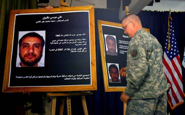 FILE PHOTO: A U.S. solider shows a picture of  Ali Mussa Daqduq (L) during a news conference at the heavily fortified Green Zone area in Baghdad July 2, 2007. REUTERS/Wathiq Khuzaie/Pool (IRAQ)/File Photo