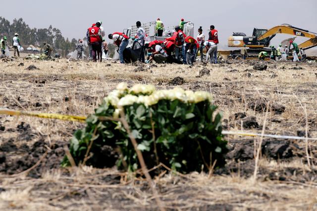 Members of the Ethiopian red cross search for remains at the Ethiopian Airlines Flight ET 302 plane crash before a commemoration ceremony at the scene of the crash, near the town of Bishoftu, southeast of Addis Ababa, Ethiopia March 13, 2019. REUTERS/Baz Ratner