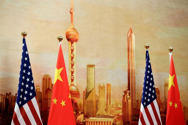 FILE PHOTO:  U.S. and Chinese flags are placed for a joint news conference by U.S. Secretary of State Mike Pompeo and Chinese Foreign Minister Wang Yi at the Great Hall of the People in Beijing, China June 14, 2018. REUTERS/Jason Lee