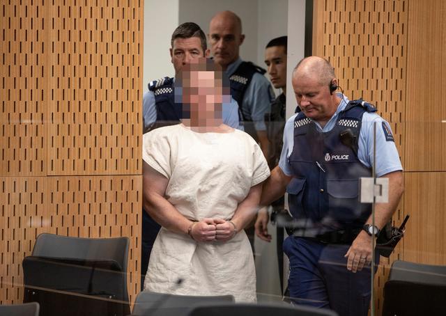 Brenton Tarrant, charged for murder in relation to the mosque attacks, is lead into the dock for his appearance in the Christchurch District Court, New Zealand March 16, 2019.   Mark Mitchell/New Zealand Herald/Pool via REUTERS. 