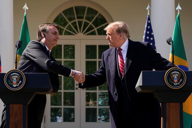 Brazil's President Jair Bolsonaro and U.S. President Donald Trump shake hands during a joint news conference in the Rose Garden of the White House in Washington, U.S., March 19, 2019. REUTERS/Kevin Lamarque