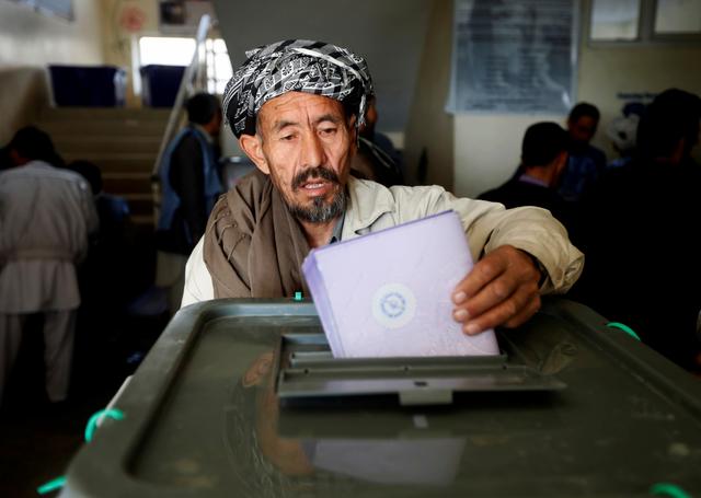 FILE PHOTO: An Afghan man casts his vote during the parliamentary election at a polling station in Kabul, Afghanistan October 21, 2018. REUTERS/Omar Sobhani/File Photo