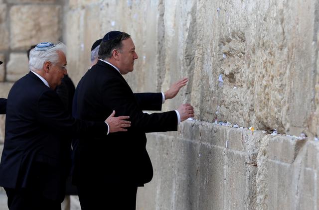 Israeli Prime Minister Benjamin Netanyahu, U.S. Secretary of State Mike Pompeo and U.S. Ambassador to Israel David Friedman touch the stones of the Western Wall during a visit to the site in Jerusalem's Old City March 21, 2019.  Abir Sultan/ Pool via REUTERS