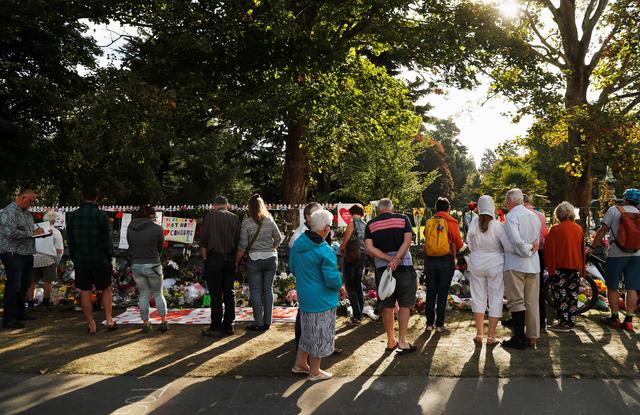 FILE PHOTO: People visit a memorial site for victims of Friday's shooting, in front of Christchurch Botanic Gardens in Christchurch, New Zealand March 19, 2019. REUTERS/Jorge Silva