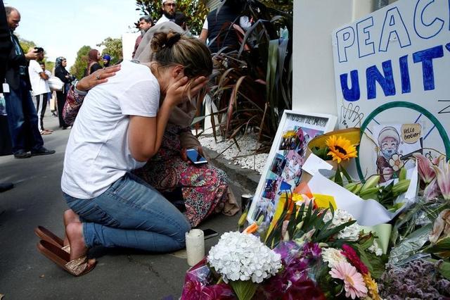 FILE PHOTO: A woman reacts at a make shift memorial outside the Al-Noor mosque in Christchurch, New Zealand March 23, 2019. REUTERS/Edgar Su