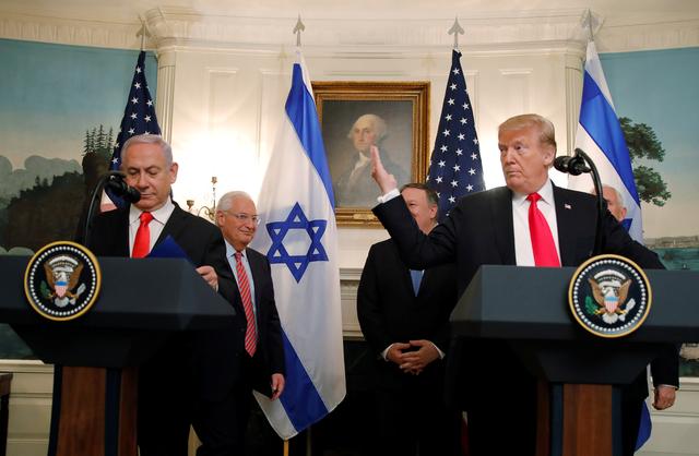 U.S. President Donald Trump gestures next to Israel's Prime Minister Benjamin Netanyahu during a ceremony to sign a proclamation recognizing Israel's sovereignty over the Golan Heights in the Diplomatic Reception Room at the White House in Washington, U.S., March 25, 2019. REUTERS/Carlos Barria