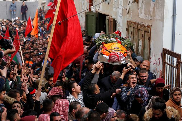 Mourners carry the body of Palestinian volunteer paramedic Sajed Mezher was killed by Israeli troops,  during his funeral in Bethlehem in the Israeli-occupied West Bank March 27, 2019. REUTERS/Mussa Qawasma
