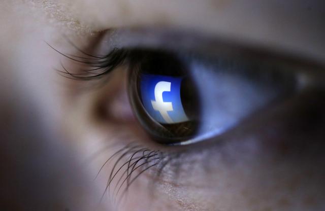 A picture illustration shows a Facebook logo reflected in a person's eye, in Zenica, March 13, 2015. REUTERS/Dado Ruvic 