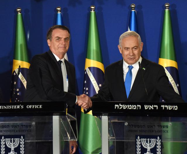 Israeli Prime Minister Benjamin Netanyahu and Brazilian President Jair Bolsonaro shake hands after they deliver joint statements in Jerusalem March 31, 2019. Debbie Hill/Pool via REUTERS