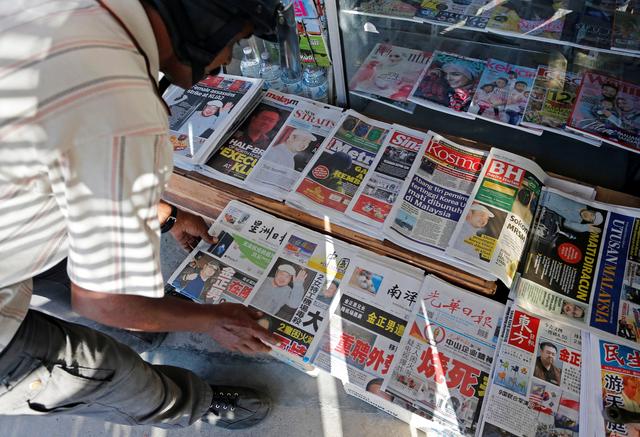 FILE PHOTO - A newspaper vendor arranges newspapers showing front pages with images of Kim Jong Nam, at a news-stand outside Kuala Lumpur, Malaysia February 15, 2017. REUTERS/Lai Seng Sin