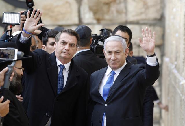 Brazilian President Jair Bolsonaro, accompanied by Israeli Prime Minister Benjamin Netanyahu, pose for a photo as they visit the Western Wall in Jerusalem's Old City.  April 1, 2019    Menahem Kahana/Pool via REUTERS