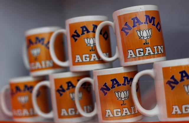 FILE PHOTO: Mugs featuring India's ruling Bharatiya Janata Party (BJP) are on display for sale outside the venue of an election rally addressed by Prime Minister Narendra Modi in Meerut in the northern Indian state of Uttar Pradesh, India, March 28, 2019. REUTERS/Adnan Abidi/File Photo