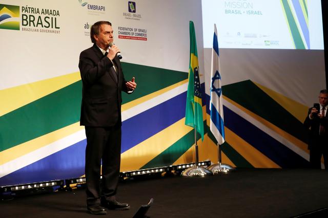 FILE PHOTO: Brazilian President Jair Bolsonaro speaks at an event with Israeli and Brazilian business people, attended by Israeli Prime Minister Benjamin Netanyahu, in Jerusalem April 2, 2019. REUTERS/Ronen Zvulun