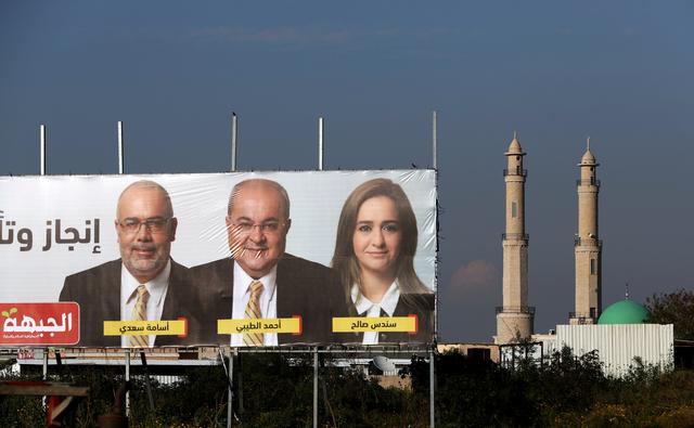 Mosque minarets are seen next to an election campaign banners depicting Ahmad Tibi, from of the Hadash-Ta'al party in the Israeli-Arab village of Taibe, northern Israel April 3, 2019. Picture taken April 3, 2019. REUTERS/Ammar Awad