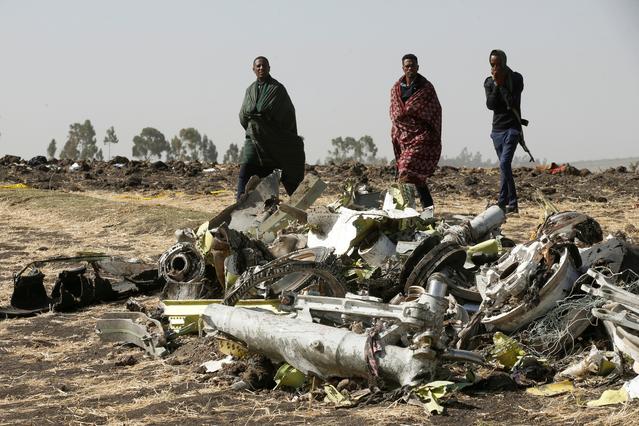 FILE PHOTO: Ethiopian police officers walk past the debris of the Ethiopian Airlines Flight ET 302 plane crash, near the town of Bishoftu, near Addis Ababa, Ethiopia March 12, 2019. REUTERS/Baz Ratner/File Photo