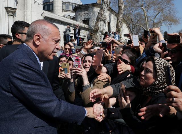 FILE PHOTO: Turkish President Tayyip Erdogan is greeted by his supporters as he leaves a mosque after the Friday prayers in Istanbul, Turkey April 5, 2019.  Cem Oksuz/Presidential Press Office/Handout via REUTERS 