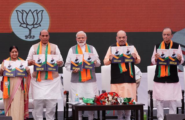 Indian Prime Minister Narendra Modi (C), chief of India's ruling Bharatiya Janata Party (BJP) Amit Shah (2-R), India's Home Minister Rajnath Singh (2-L) India's Foreign Minister Sushma Swaraj (L) and India's Finance Minister Arun Jaitley display copies of their party's election manifesto for the April/May general election, in New Delhi, India, April 8, 2019. REUTERS/Adnan Abidi