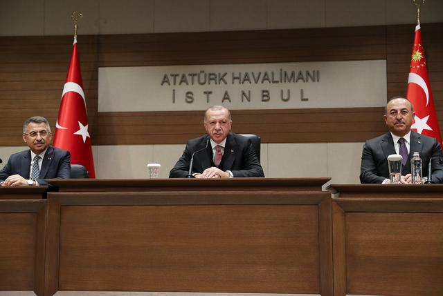 Turkish President Tayyip Erdogan, accompanied by Vice President Fuat Oktay and Foreign Minister Mevlut Cavusoglu, talks during a news confrence at Ataturk International Airport in Istanbul, Turkey April 8, 2019. Kayhan Ozer/Presidential Press Office/Handout via REUTERS