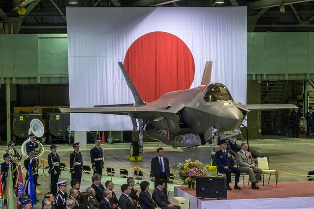 Senior leaders of Japan’s Ministry of Defense, U.S. Forces Japan, Pacific Air Forces and Lockheed Martin gather in a Japan Air Self-Defense Force hangar for the commemorative ceremony welcoming the first operational F-35A Lightning II to JASDF's 3rd Air Wing at Misawa Air Base, Japan, February 24, 2018. Picture taken February 24, 2018.  U.S. Air Force/Tech. Sgt. Benjamin W. Stratton/Handout via REUTERS